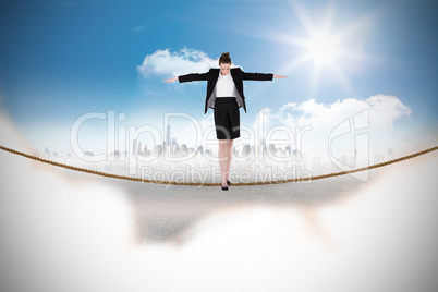 Composite image of businesswoman performing a balancing act