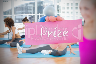 Fit blonde holding card saying prize