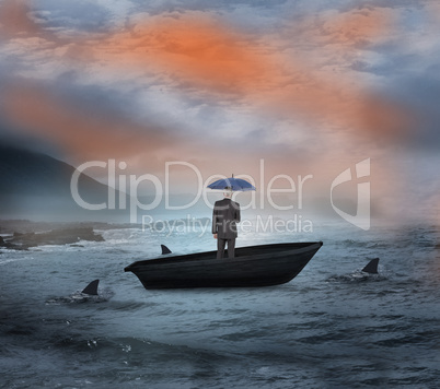 Composite image of businessman holding umbrella in a sailboat