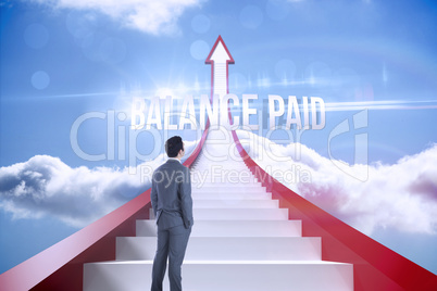 Balance paid against red steps arrow pointing up against sky