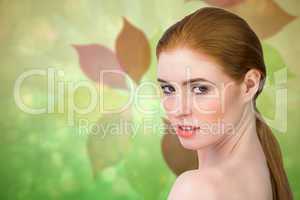 Composite image of beautiful redhead looking at camera