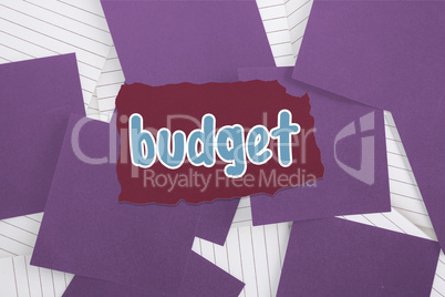 Budget against purple paper strewn over notepad