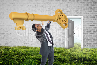 Composite image of stressed businessman carrying large key