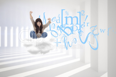 Composite image of brunette cheering while using laptop