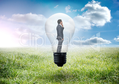 Composite image of thinking businessman in light bulb