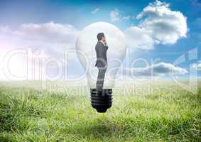 Composite image of thinking businessman in light bulb