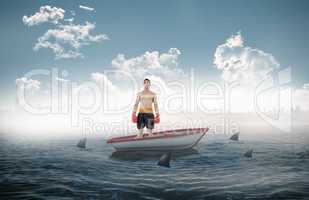 Composite image of boxer standing in a sailboat