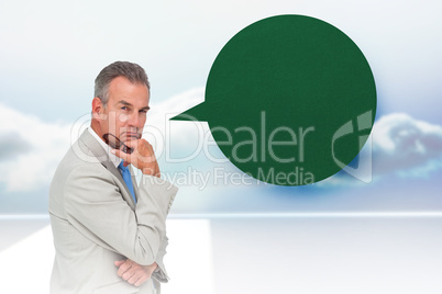 Composite image of thinking businessman with speech bubble