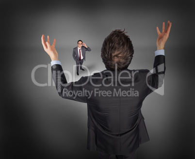 Composite image of gesturing businessman with tiny businessman