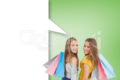 Composite image of two young women with shopping bags with speec Composite image of two young women with shopping bags with speec