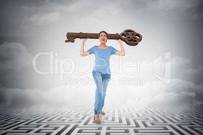 Composite image of annoyed brunette carrying large key