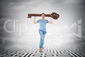 Composite image of annoyed brunette carrying large key