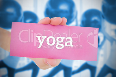 Woman holding pink card saying yoga