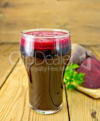 Juice beet in tall glass on board
