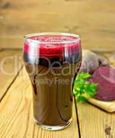 Juice beet in tall glass on board