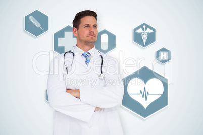 Composite image of handsome doctor with arms crossed