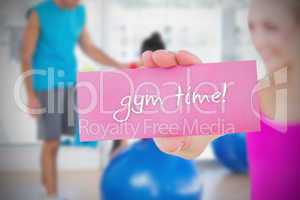 Fit blonde holding card saying gym time