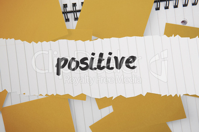 Positive against yellow paper strewn over notepad