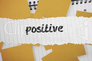 Positive against yellow paper strewn over notepad