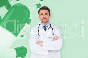 Composite image of handsome young doctor with arms crossed