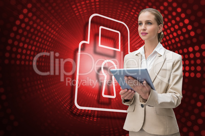 Composite image of lock and businesswoman using tablet