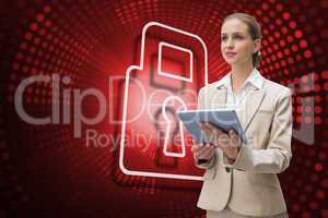 Composite image of lock and businesswoman using tablet