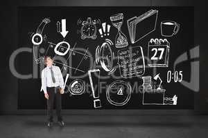Composite image of businessman looking up