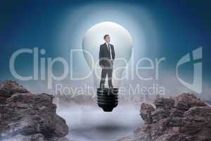 Composite image of thinking businessman in light bulb