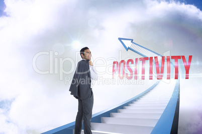 Positivity against red staircase arrow pointing up against sky