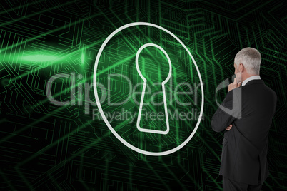 Composite image of keyhole and businessman looking