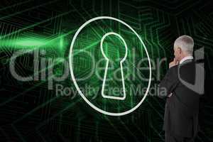 Composite image of keyhole and businessman looking