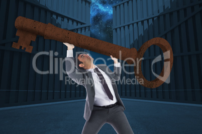 Composite image of unsmiling businessman carrying large key