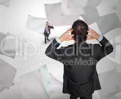 Composite image of stressed businessman with hands on head with
