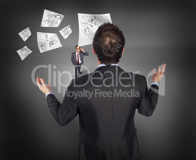 Composite image of gesturing businessman with tiny businessman