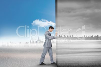 Composite image of businessman pushing away scene