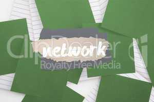 Network against green paper strewn over notepad