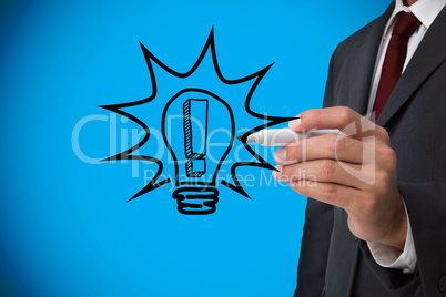 Composite image of businessman drawing light bulb