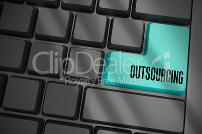 Outsourcing on black keyboard with blue key