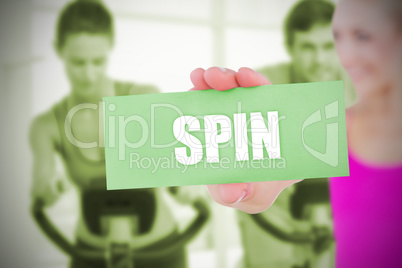 Fit blonde holding card saying spin