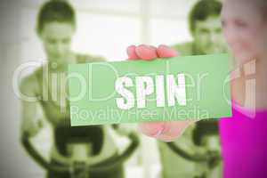 Fit blonde holding card saying spin