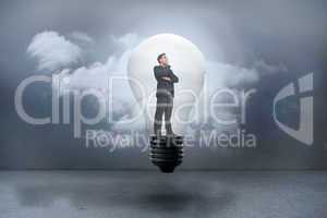 Composite image of thinking businessman in light bulb