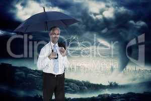 Composite image of happy businessman holding umbrella