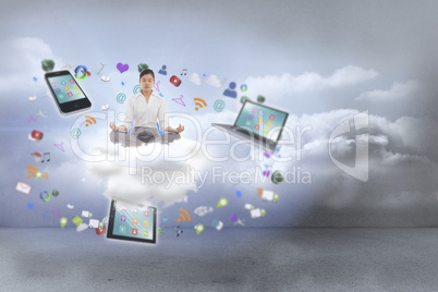 Composite image of businesswoman sitting in lotus pose