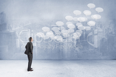 Composite image of serious businessman with hands on hips