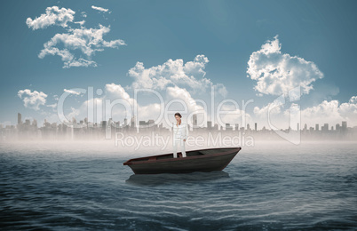 Composite image of thinking businesswoman in a sailboat