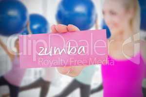 Fit blonde holding card saying zumba