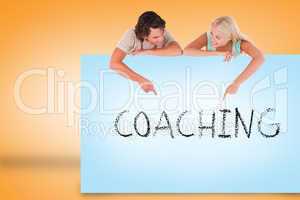 Attractive couple showing card with coaching