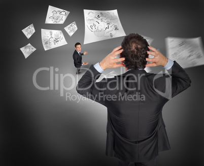 Composite image of stressed businessman with hands on head with