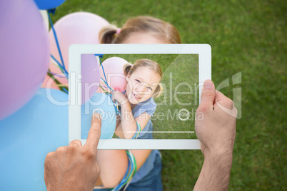 Composite image of hand holding tablet pc