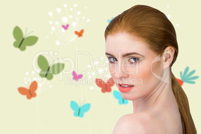 Composite image of beautiful redhead looking at camera